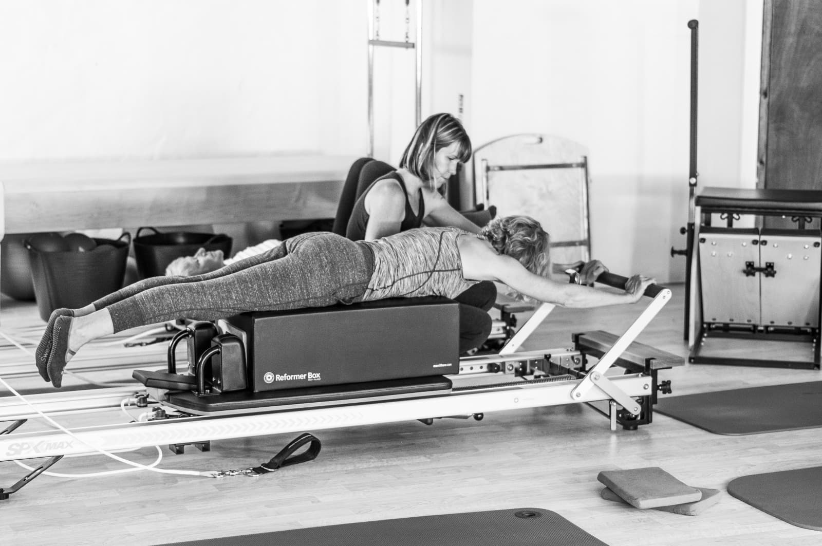 Debbie West teaching a client on the Pilates reformer